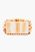 Beige marbled rectangular box clutch by Cult Gaia, featuring round tan and cream acrylic pearl beads—an elegant accessory for any occasion.