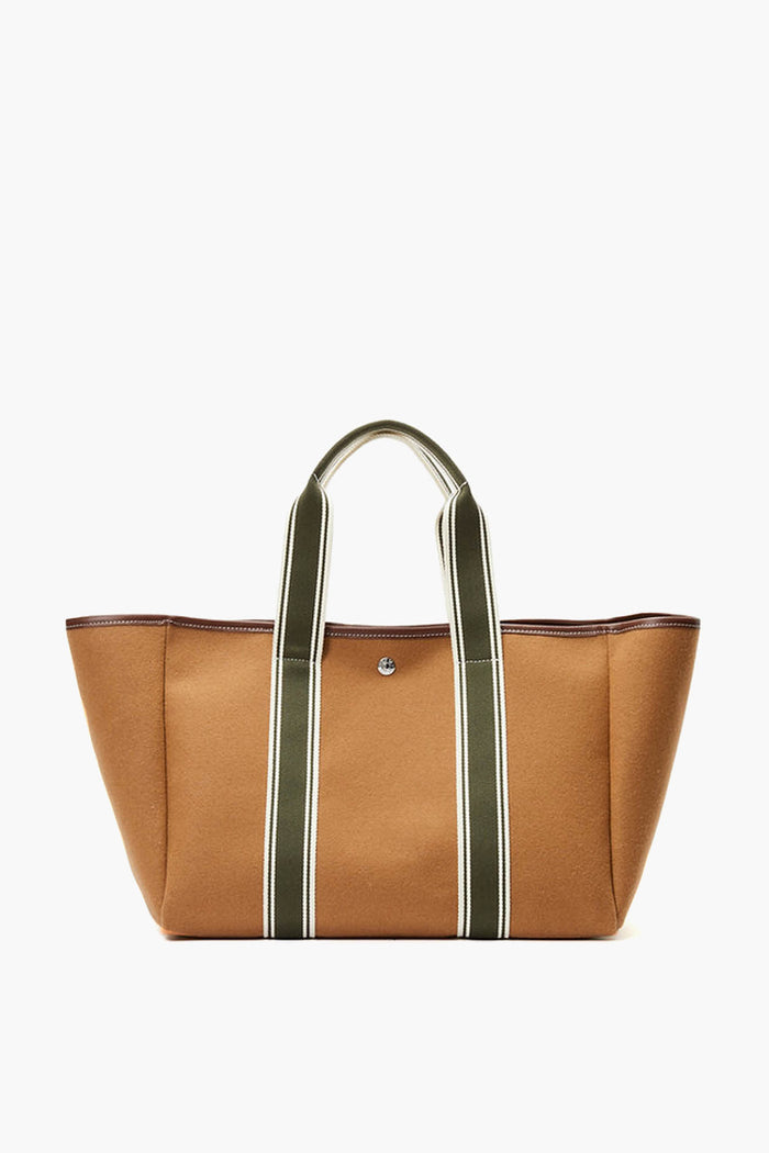 A brown canvas Rue de Verneuil tote bag featuring olive green and white striped handles for a touch of luxury.