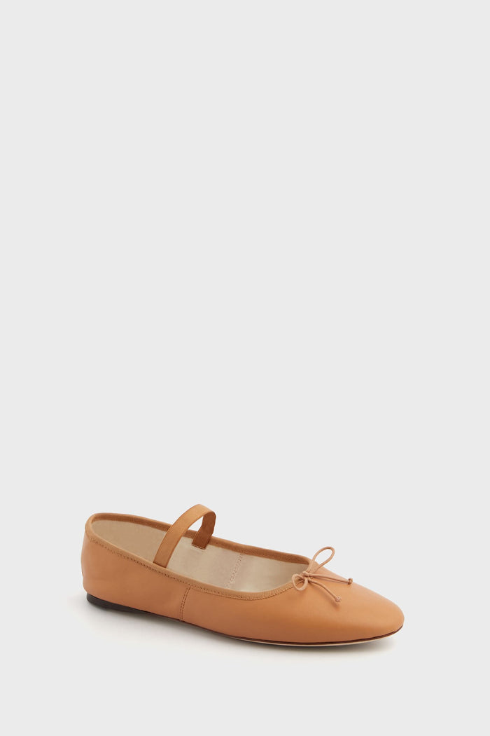 Loeffler Randall ballet flat made of soft lamb leather, features a thin strap over the instep, a delicate bow on the toe, and a flat black sole.