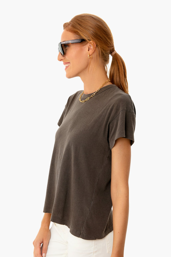 Young woman in oversized sunglasses wearing THE GREAT's Chestnut Boxy Crew Tee; a classic, effortless, high-end staple with a boxy fit and flattering sleeves.