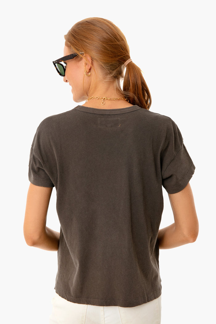 Back view of a woman wearing the classic Chestnut Boxy Crew Tee, showcasing its effortless, high-end design with angled sleeves, perfect for a fun, confident look.