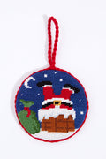 Smathers and Branson Round Santa Needlepoint Ornament features a hand-stitched design with Santa’s legs in a chimney, green sack, snow, and moon, finished with a red braided loop—a charming holiday accent for your tree.