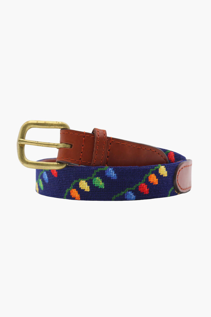 A navy blue fabric belt with multicolored embroidery, brown leather accents, and a brass buckle—Hand-stitched Children's Belt by Smathers and Branson.