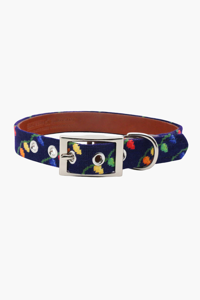 This Smathers and Branson navy fabric belt features a silver buckle and colorful embroidered parrots, inspired by needlepoint dog collar designs.