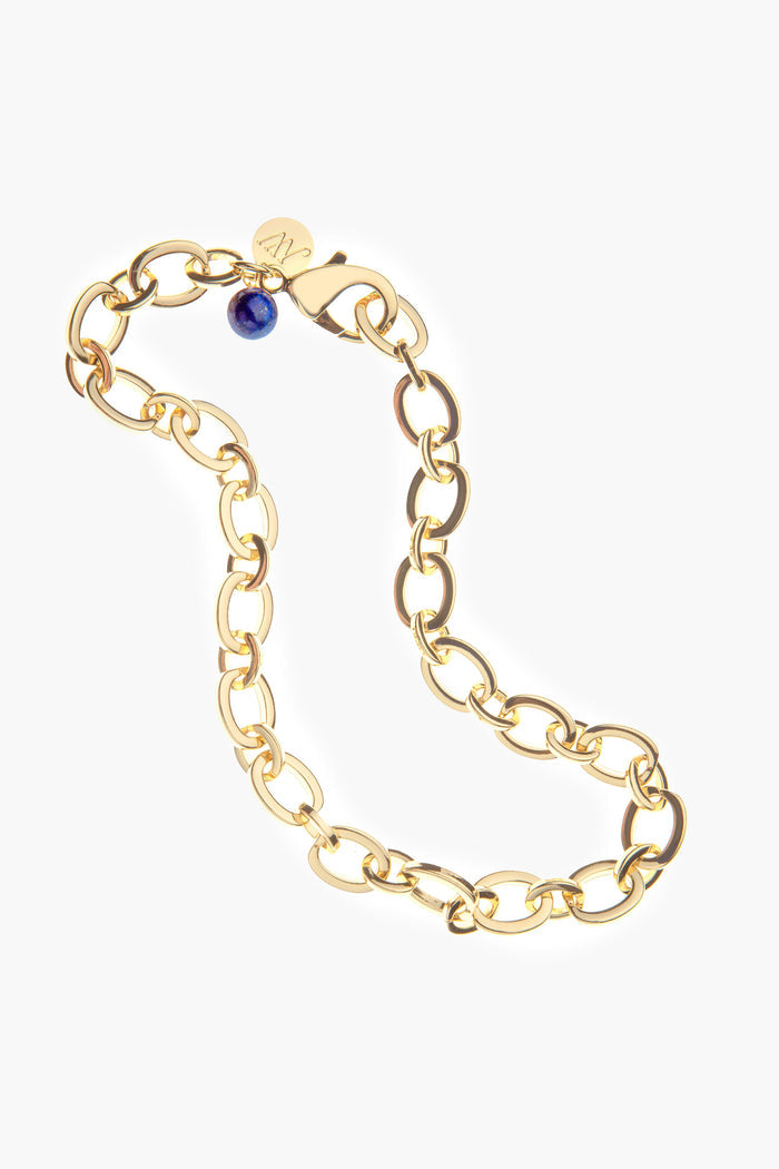 Jane Win gold chunky chain bracelet featuring oval links, a lapis bead accent, and a round gold tag.