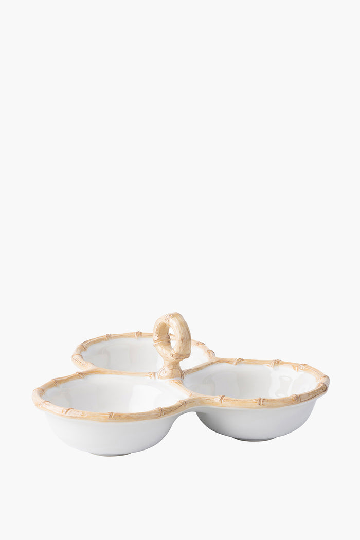 Juliska's Bamboo collection white ceramic stoneware triple server features three connected sections, a central handle, and bamboo-patterned rims.