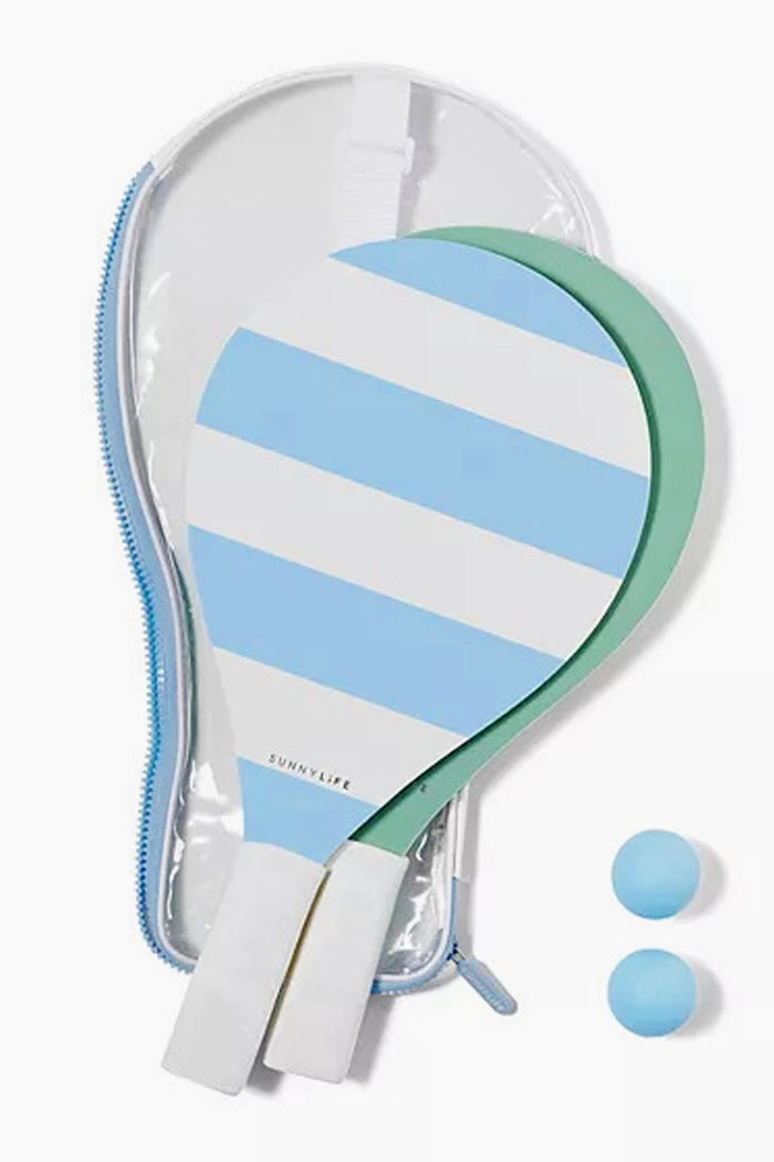 Sunnylife's set includes two wooden paddleball rackets with light blue and white stripes, two blue balls, and a clear zippered carrying case—perfect summer essentials for outdoor games or beach fun.