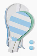 Sunnylife's set includes two wooden paddleball rackets with light blue and white stripes, two blue balls, and a clear zippered carrying case—perfect summer essentials for outdoor games or beach fun.