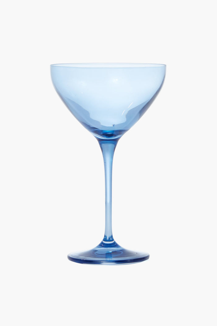 The Estelle Colored Glass blue-tinted coupe glass, featuring a wide bowl and tall, slender stem, exemplifies luxury stemware and the elegance of colored glass martini glasses.