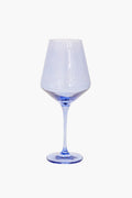 A clear wine glass with a subtly blue-tinted base and stem, hand-blown by Estelle Colored Glass for an elegant touch.