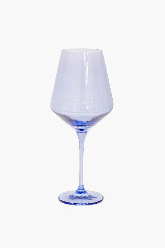 A clear wine glass with a subtly blue-tinted base and stem, hand-blown by Estelle Colored Glass for an elegant touch.