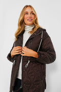 A woman in a black quilted Varley jacket, the perfect cold-weather staple.