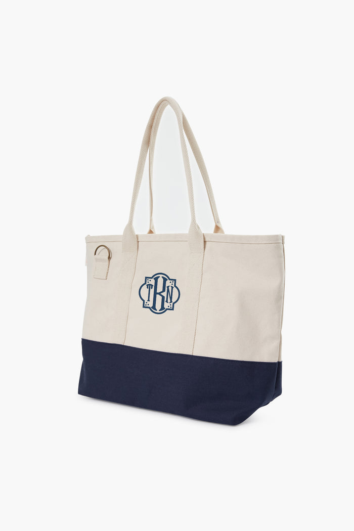 Colorblock Utility Tote: A classic and effortless two-tone canvas bag with a top zip, internal pocket, and key ring. Perfect for stylish, high-end, everyday adventures.