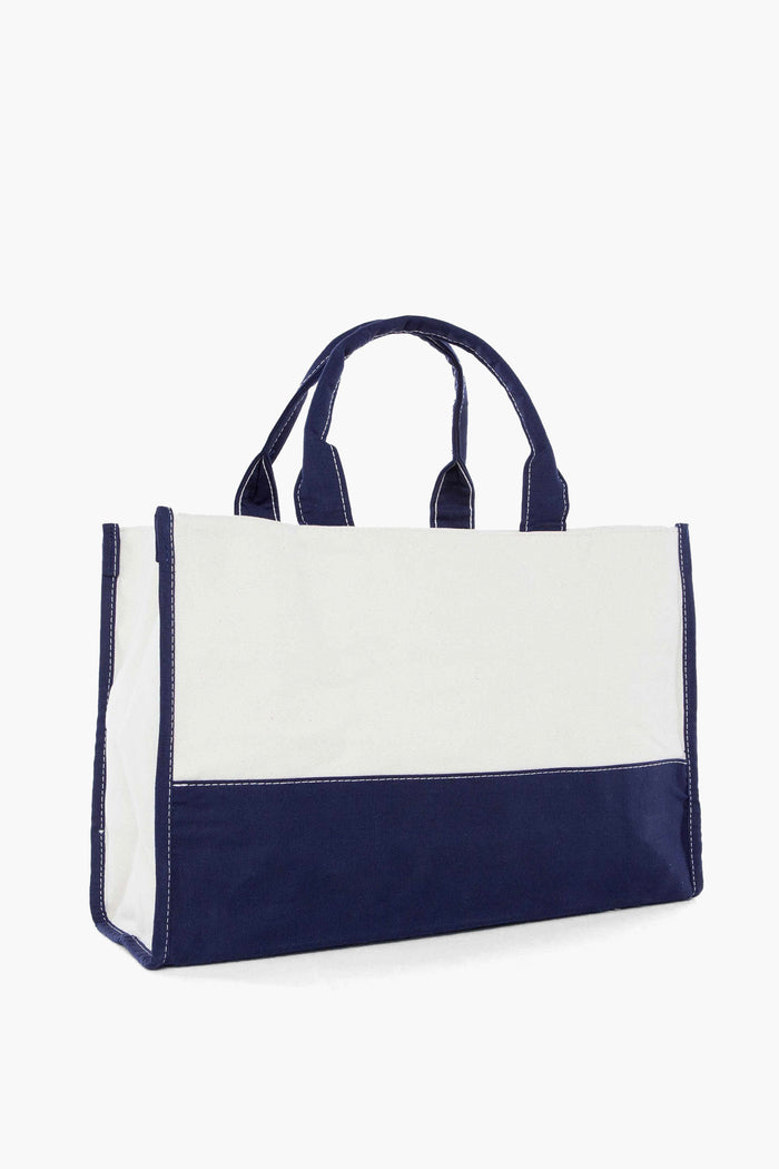 Classic Colorblock Vivera Bag: an effortless, high-end off-white canvas tote with navy-blue accents and short handles, perfect for versatile, fun adventures or errands.