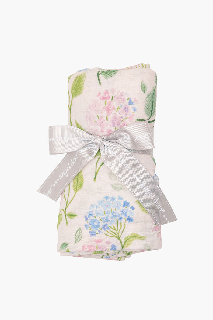 A folded floral-patterned organic cotton muslin fabric from Angel Dear, secured with a gray ribbon—an ideal choice for a nursery essential or baby swaddle.
