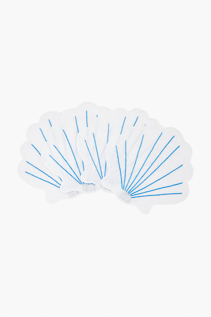Five white, shell-shaped napkins with blue lines from Chefanie are arranged in a fan pattern, evoking elegant clam shells—perfect for coastal cocktail settings.