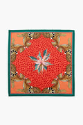 Ardmore Design square silk scarf featuring a green border, red and orange leopard print center, floral motif, and inward-facing illustrated leopards in each corner—crafted by South African artisans for a unique modern collectible.