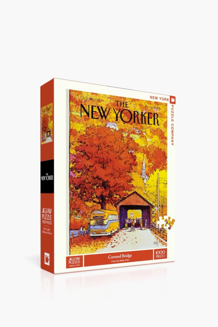 A 1000-piece puzzle by New York Puzzle Company with a linen-style finish, featuring a classic The New Yorker cover of a covered bridge, autumn foliage, and a school bus.