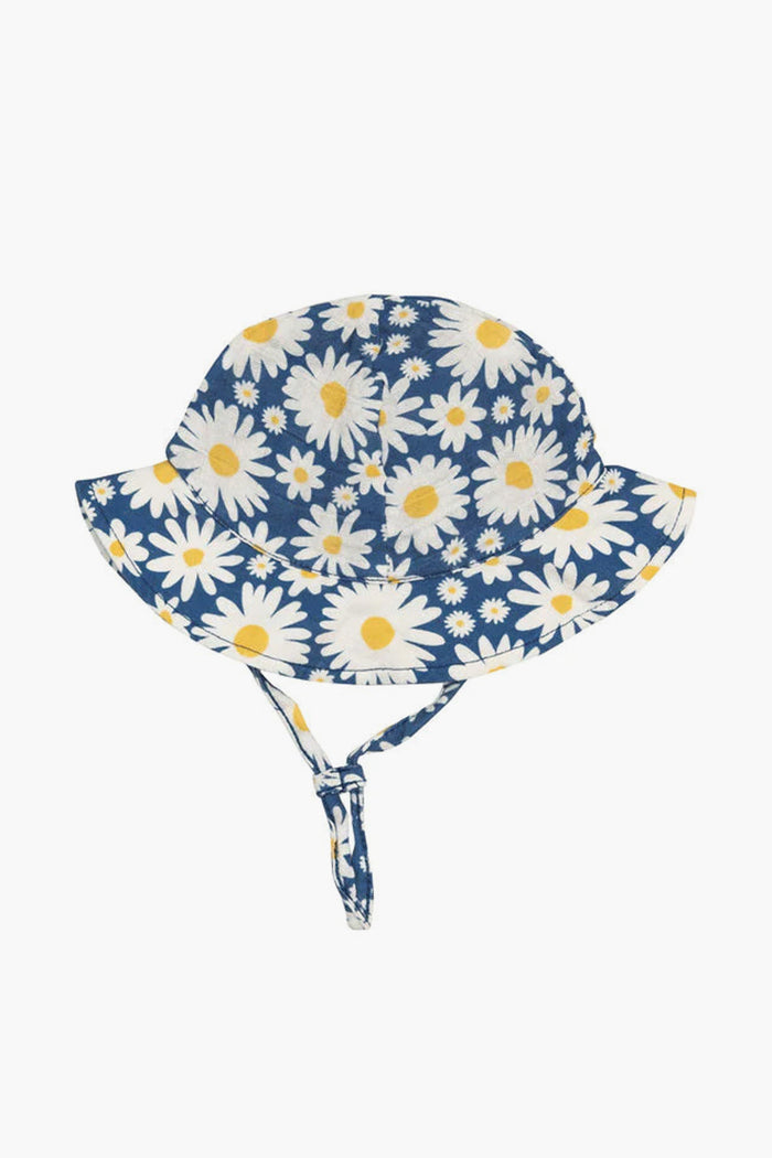 The Angel Dear blue bucket hat features a white and yellow daisy pattern, wide brim, and adjustable chin strap. This adorable floral print sunhat is perfect for babies to wear on sunny days.