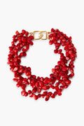 Kenneth Jay Lane multi-strand coral necklace with irregular red resin beads and a gold clasp—an eye-catching piece of costume jewelry.