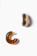 A pair of brown, translucent resin halo hoop earrings with a chunky design and gold-plated brass accents from Lizzie Fortunato.