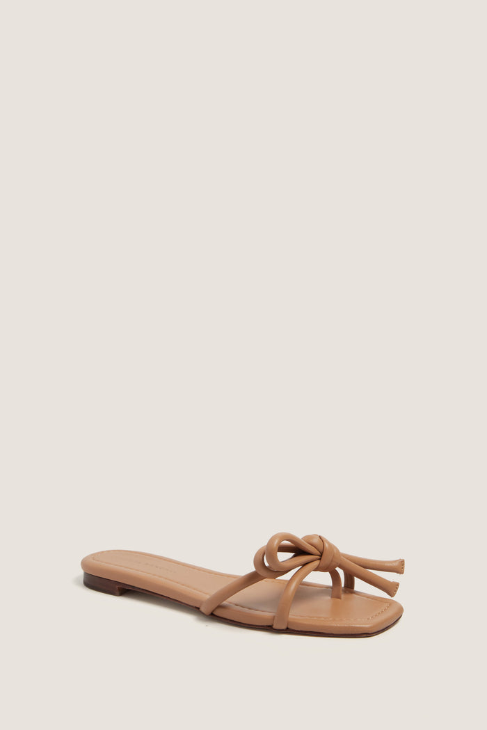 Dune Nappa Hadley Leather Bow Flat Sandal: a classic, effortless slide with a square toe and chic knotted straps, perfect for a high-end, fun look.