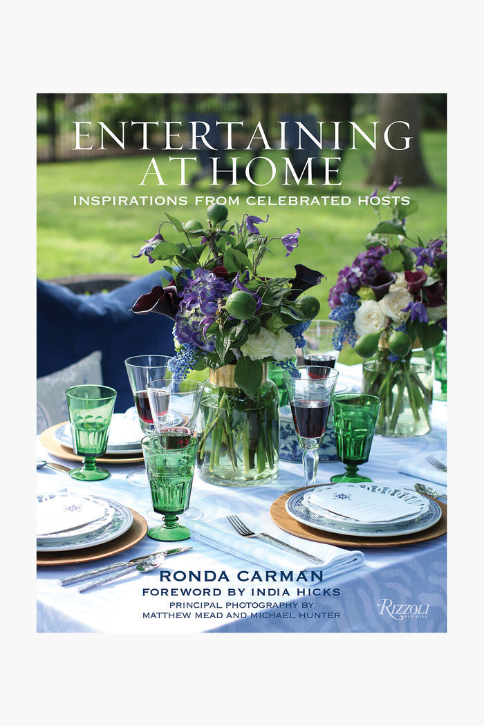 A Rizzoli book cover shows a set outdoor dining table with green glassware, floral centerpieces, and plates; the text reads "Entertaining at Home by Ronda Carman"—ideal for party planning ideas and easy recipes.