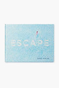 Rizzoli's book ESCAPE by Gray Malin showcases stunning travel photography, with a cover featuring a swimmer in a clear blue pool that evokes the beauty of exotic vacation spots.
