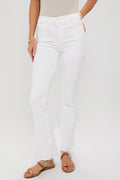 Wearing high-waisted, white MOTHER Weekender Fray jeans with frayed hems, a beige top, gold bracelet, and tan sandals for an effortlessly stylish look.
