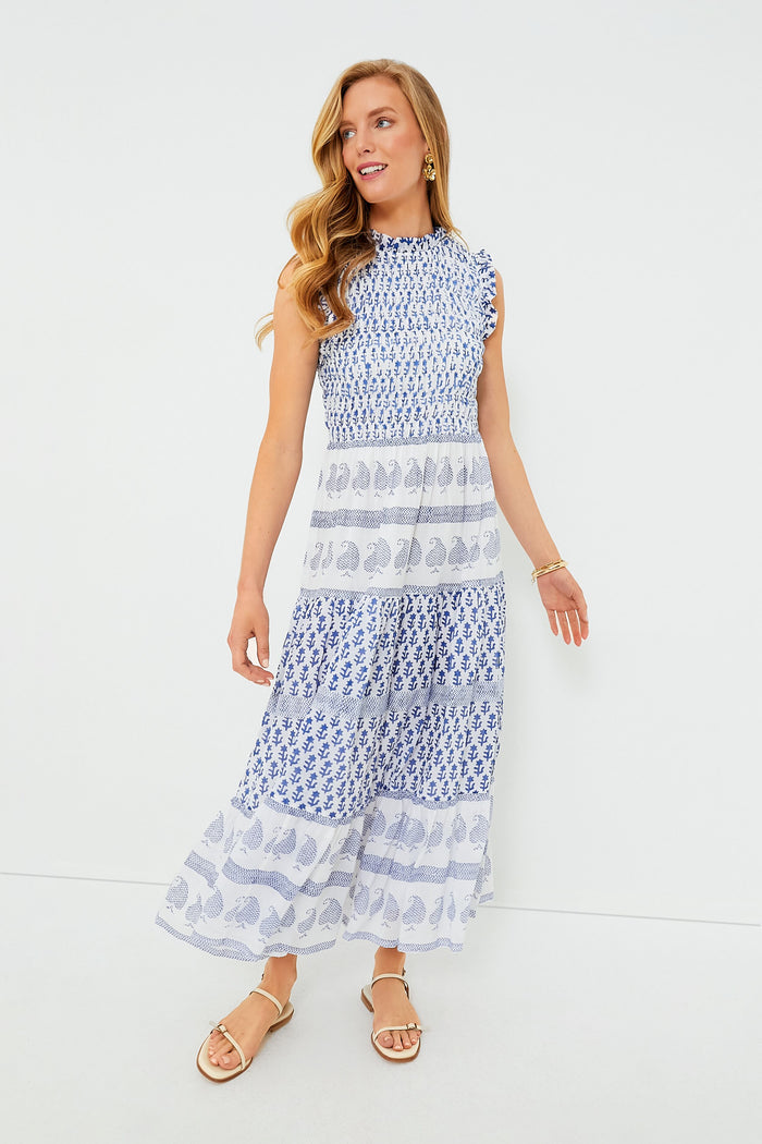A woman models the Oliphant Flora Blue Dress, a sleeveless, ankle-length cotton piece featuring blue and white block print patterns as she looks to the side.