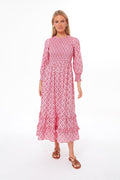 A woman wears a Pink City Prints Isabel Dress in Mogul Rose, a vibrant handmade pink dress.