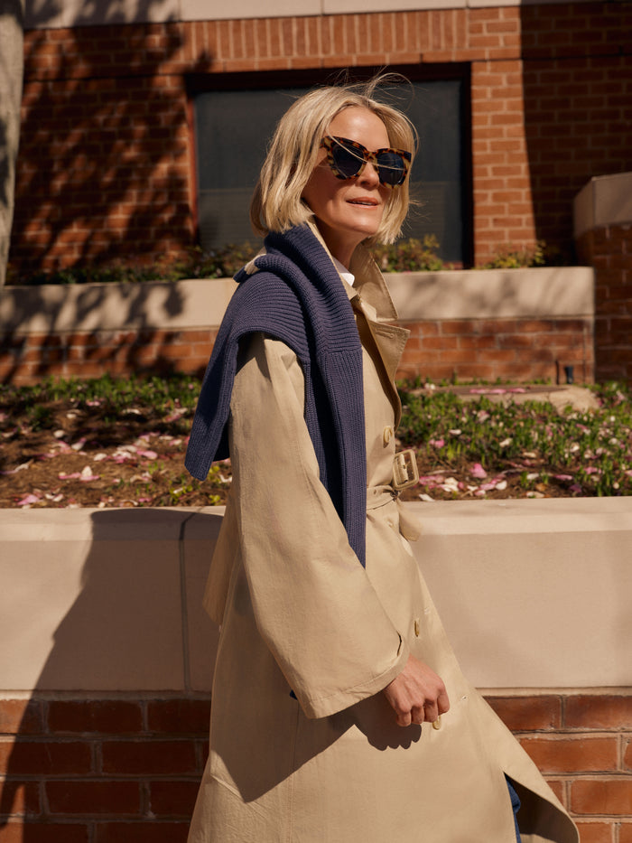 Woman wearing Exclusive Tortoise Not Standard Sunglasses exudes classic, effortless style with oversized frames, perfect for high-end, fun fashion in any season.
