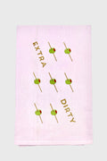 A unique gift: the Lynen embroidered tea towel showcases green olives on toothpicks and “EXTRA DIRTY” diagonally across soft white fabric.