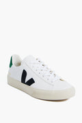 The VEJA white low-top sneaker is crafted from ecological materials, featuring a black V logo, green heel detail, and white laces—a stylish, sustainable choice.
