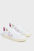 A pair of white VEJA sneakers featuring light purple V logos and purple heel accents, made from recycled materials for eco-friendly style.