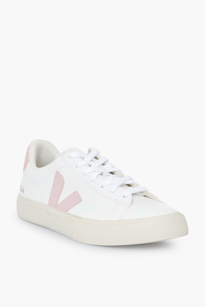The VEJA low-top sneaker features a white upper, light pink detailing, white laces, and a beige rubber sole, showcasing the brand's stylish and sustainable design.