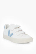 A white VEJA sneaker with two Velcro straps, light blue accents, and a side V logo, made from chrome free leather for eco-friendly style.