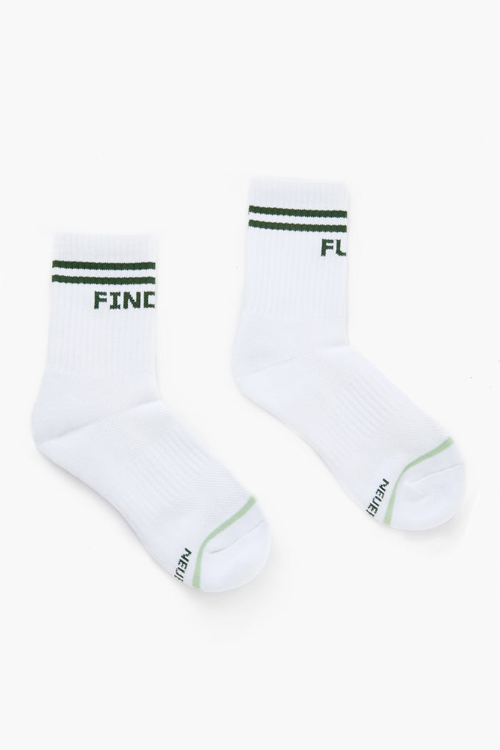 A pair of Tnuck Sport white crew-length socks with green stripes and text, laid flat.