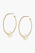 ASHA gold vermeil hoop earrings, each featuring a delicate white flower-shaped charm reminiscent of elegant mother-of-pearl.