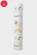 A roll of white Tuckernuck x Jollie gift wrap with colorful floral illustrations is shown. A Childrens National Hospital benefit badge appears in the upper left, inspired by the Fresh Buds Yoga Mat design.