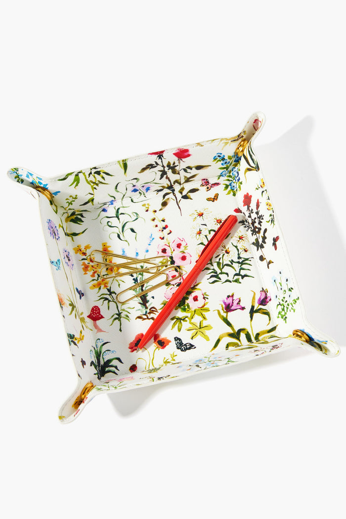 The Neely & Chloe x Inslee rectangular catch-all tray with floral patterns holds a red pen and two gold hairpins, making it a perfect home essential.