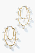 Mignonne Gavigan gold hoop earrings with two overlapping loops, each accented by evenly spaced dangling white pearls. A classic, elegant twist on pearl hoops.