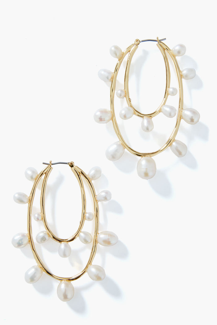 Mignonne Gavigan gold hoop earrings with two overlapping loops, each accented by evenly spaced dangling white pearls. A classic, elegant twist on pearl hoops.