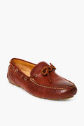 The Sperry brown full-grain leather loafer features stitching details, a front bow, and a rubber sole. Shown at a slight angle, it's ideal as a driving moccasin or for casual wear.