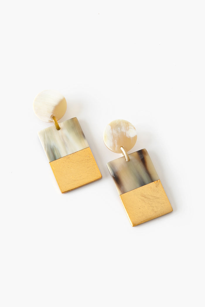 Sunshine Tienda’s handcrafted rectangular drop earrings feature a circular top, marbled pattern on the upper half, and gold-colored lower half—perfect vacation jewelry for your accessories collection.