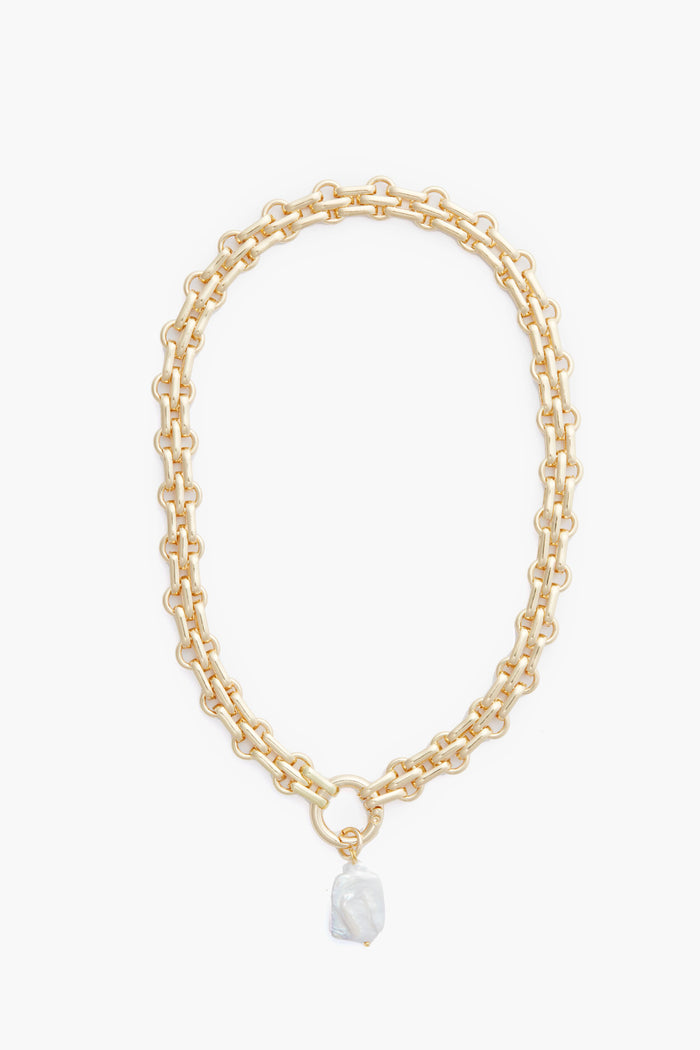 Petit Moments chunky chain necklace features large oval gold-tone links and a unique irregular faux pearl pendant, elegantly displayed.