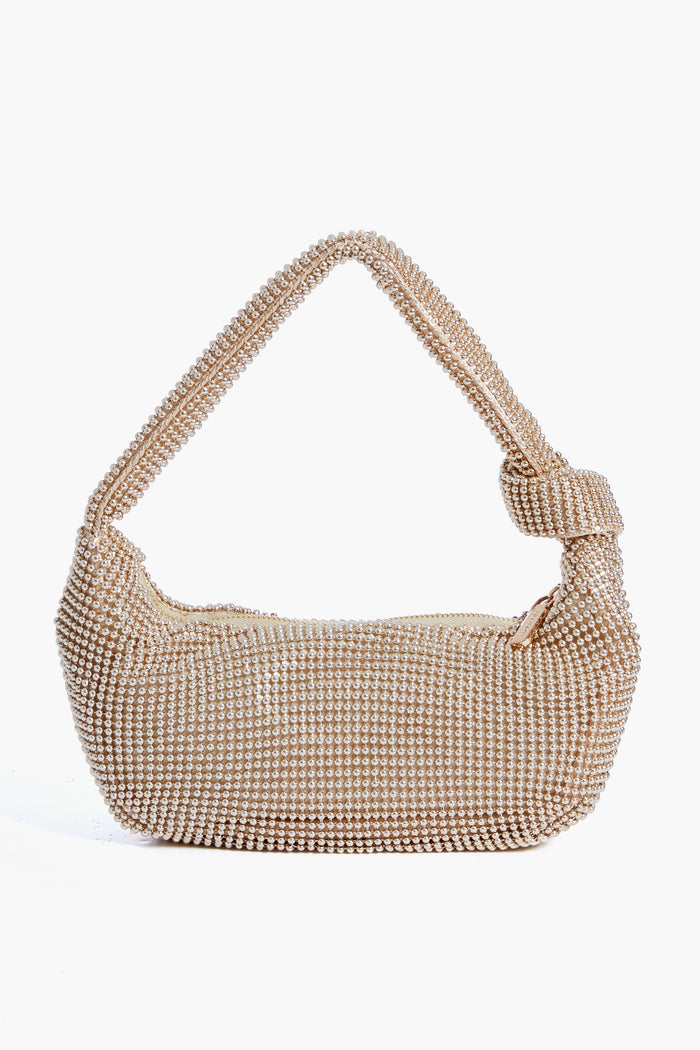 The Olga Berg tan handbag features small, shiny pearl-like beads, a single handle, and a chic knotted detail, combining classic style with evening bag elegance.