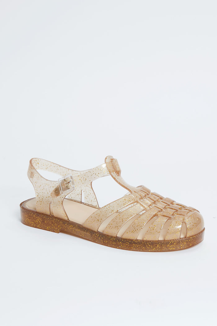 Melissa clear jelly sandals with a closed toe, adjustable strap, and gold glitter in the sole and straps—ideal for fans of glitter sandals and sustainable fashion.