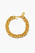 A gold-plated brass chain link bracelet by Lizzie Fortunato features a round, interlocking design with a small oval tag near the clasp.