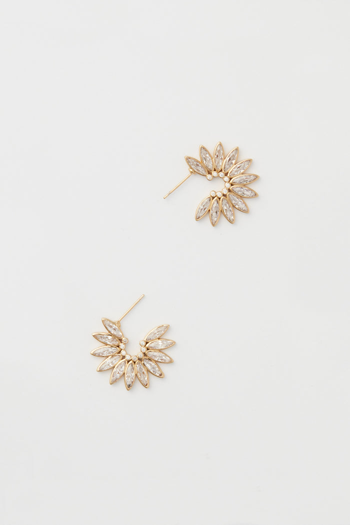 The Mignonne Gavigan Ines Earrings feature a fan-shaped design in 14k gold-plated finish, each accented with multiple marquise-shaped crystals arranged in a sparkling semi-circular pattern.
